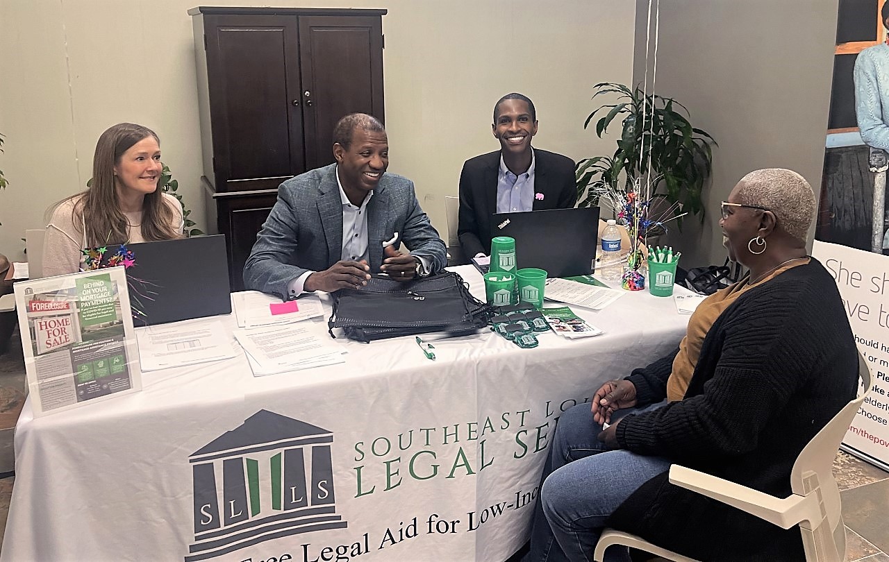 Christy Kane, Entergy's pro bono counsel, and Marcus Brown, Entergy's executive vice president and general counsel, with customers at Entergy's customer care center on EmPOWERing Pro Bono Day.